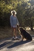 Rural Auburn, California  Woman walking with her dog down a country road, Auburn California