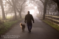 Rural Auburn, California  Man walking his dog down a foggy country road, Auburn California