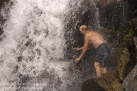 Hiker, Canyon Creek, California Hiker cooling off beneath a waterfall on Canyon Creek, Tahoe National Forest, California