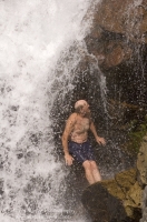 Hiker, Canyon Creek, California Hiker cooling off beneath a waterfall on Canyon Creek, Tahoe National Forest, California