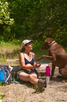 DH-0588 Woman eating her picnic lunch, while her dog politely begs for a bite, North Fork of the American River, Weimar, California.