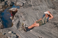 DH-0602 Woman relaxing on a rock, while her dog watches, North Fork of the American River, Weimar, California.