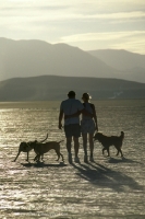 Black Rock Desert, Nevada Couple walking with their dogs on the playa, in the Black Rock Desert, Nevada