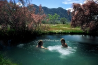 Black Rock Desert, Nevada Couple soaking in the hot spring at Frog Ranch, Black Rock Desert, Nevada