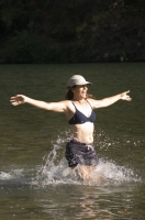 Lake Clementine, Auburn, California  Woman playing in Lake Clementine on a hot summer day, Auburn, California