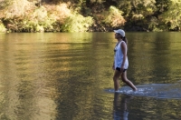 Lake Clementine, Auburn, California  Woman cooling off in Lake Clementine on a hot summer day, Auburn, California