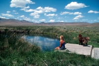 Soldier Meadows Hot Spring, Nevada Woman and her dog enjoy a hot spring in Soldier Meadows, Nevada