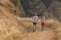 Couple and dog running, Auburn, California Couple running with their dog on the Stagecoach Trail. an old stage road from Auburn to Foresthill