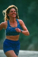 Woman running along the American River, California Woman running along the north fork of the American River, near Weimar, California