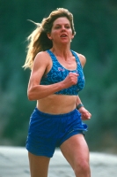 Woman running along the American River, California Woman running along the north fork of the American River, near Weimar, California