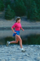 Woman running along Stampede Reservoir, California Woman running on the shore at Stampede Reservoir, near Truckee, California