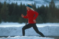 Senior woman running in winter, Truckee, California Woman running in the snow, Truckee, California
