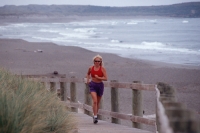 Bodega Dunes State Park, California Woman running at Bodega Dunes State Park, California