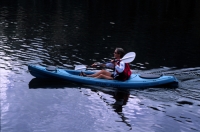 Woman kayaking Lindsey Lake, California  Woman kayaking on Lindsey Lake, Tahoe National Forest, California