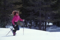 Woman snowshoeing, Clair Tappaan Lodge, California Woman running in snowshoes at Clair Tappaan, Soda Springs, California