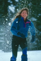 Woman snowshoeing, Castle Peak, California Woman running in snowshoes at Castle Peak, California