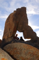DT-CA-05-09 Woman and dog sitting in an arch, Alabama Hills, Lone Pine, California