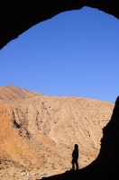 DT-CA-07-12 Man exploring a cave in Cottonwood Canyon, Death Valley National Park, California