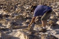 Devil's Golf Course, Death Valley National Park, California  Man examining the salt at the Devil's Golf Course, Death Valley National Park, California
