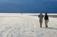 Badwater Basin, Death Valley National Park, California  Visitors walking on the salt flats at Badwater Basin, Death Valley National Park, California