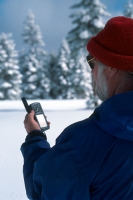 Man using a GPS, California  Man navigating by GPS on a winter trail, Robb's Peak, California
