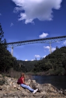 Woman looking at the Foresthill Bridge, Auburn, California Woman viewing the Foresthill Bridge, from the confluence of the north and middle forks of the American River, Auburn, California