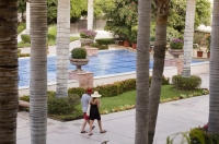 Cabo San Lucas, Mexico Couple walking through the grounds at Pueblo Bonito Rose' Resort, Cabo San Lucas, Baja California, Mexico