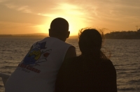 Cabo San Lucas, Mexico Couple watching the sunset during a sunset dinner cruise, Cabo San Lucas, Baja California, Mexico.