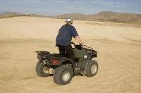 Cabo San Lucas, Mexico Man riding a Quad on the playa near Migrino, Baja California, Mexico