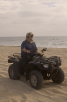 Cabo San Lucas, Mexico Man riding a Quad on the playa near Migrino, Baja California, Mexico