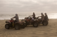 Cabo San Lucas, Mexico Group of tourists riding Quads on the playa near Migrino, Baja California, Mexico