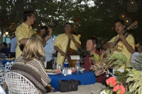 Cabo San Lucas, Mexico Musicians playing for a couple dining at La Golondrina Restaurant, Cabo San Lucas, Baja California, Mexico