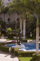 Cabo San Lucas, Mexico Worker cleans near the reflecting pool, Pueblo Bonito Rose' Resort, Cabo San Lucas, Baja California, Mexico