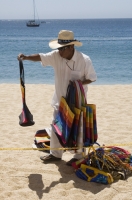 Cabo San Lucas, Mexico  Beach vendor trying to make a sale to tourists, Cabo San Lucas, Baja California, Mexico