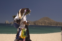 Cabo San Lucas, Mexico Female beach vendor walking on the beach (playa), Cabo San Lucas, Baja California, Mexico 