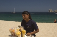 Cabo San Lucas, Mexico Female beach vendor on the beach (playa), Cabo San Lucas, Baja California, Mexico 