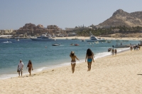 Cabo San Lucas, Mexico Tourists walking on the beach (playa), Cabo San Lucas, Baja California, Mexico