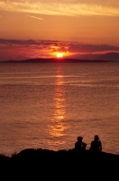 Children watching the sunset from San Juan Island, Washington Children enjoying the sunset at San Juan County Park, Washington